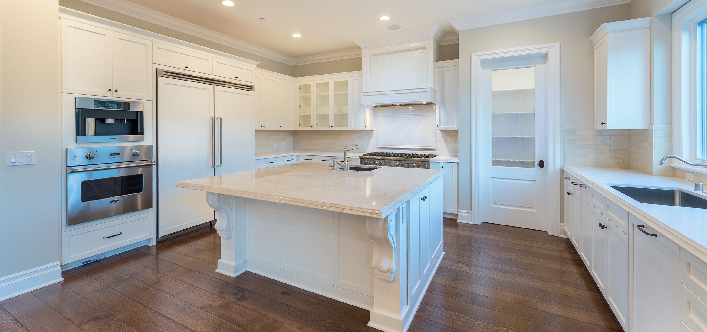 White kitchen with stainless steel appliances.