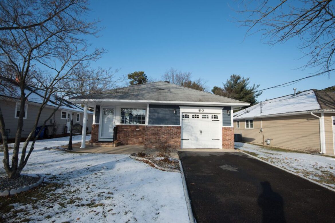 House with a garage door in the snow.