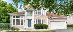 Two-story beige house with a garage.