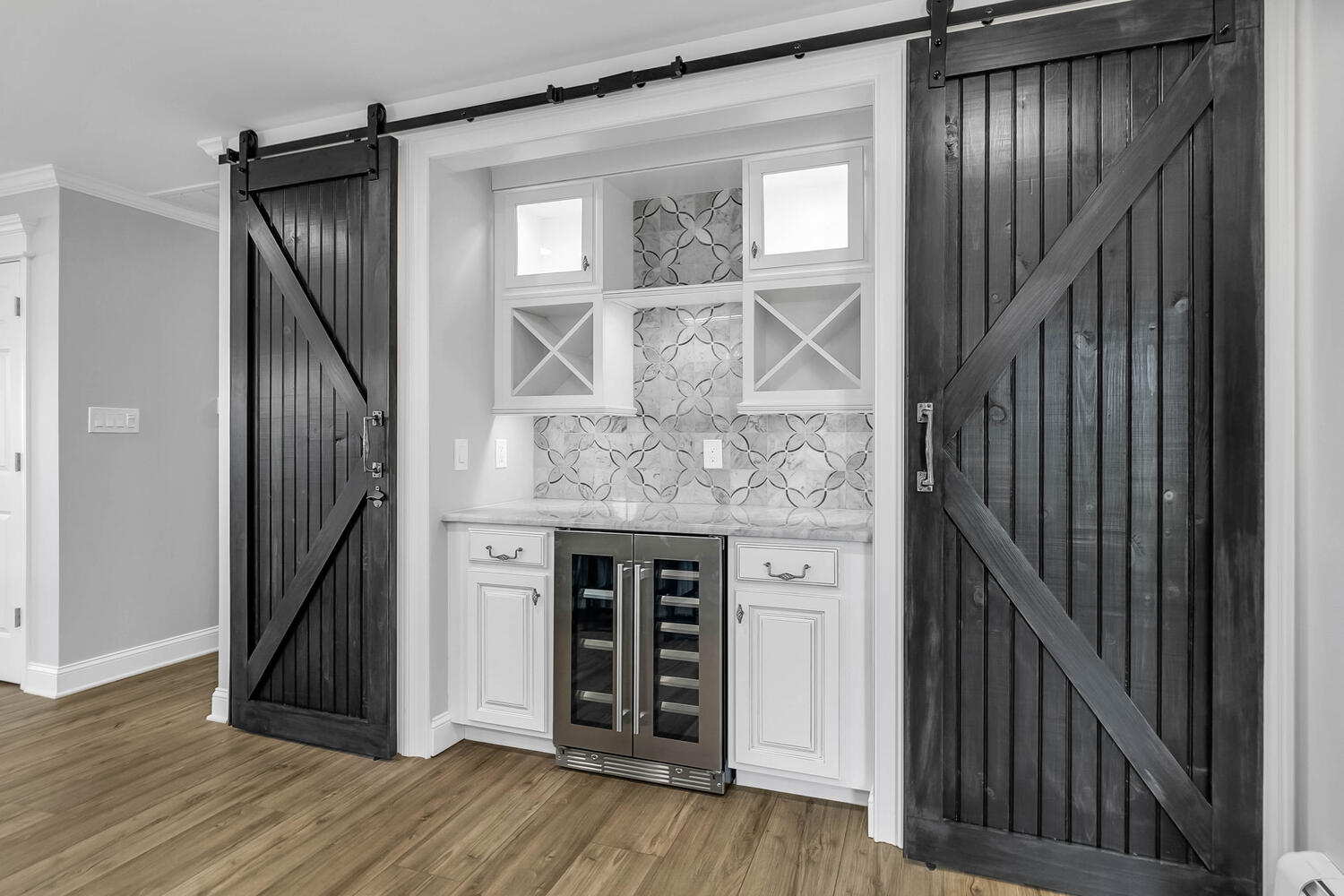Barn doors and wine fridge in a kitchen.