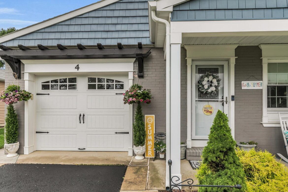 House with white garage door and front porch.