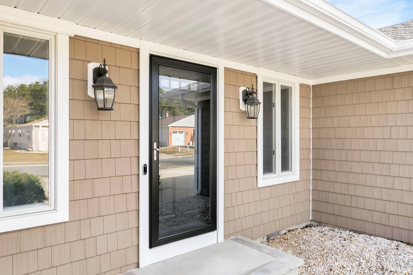 Front door with white trim and black lights.