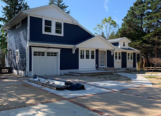 Blue house with white trim and garage.