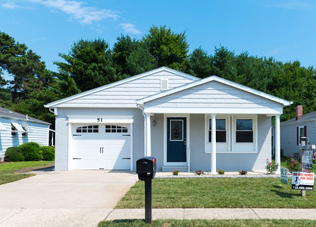 White suburban house with a garage door.