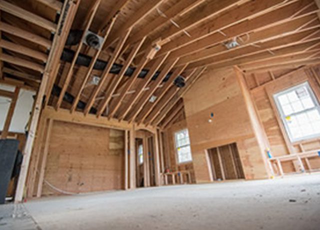 Unfinished interior with wood framing and plywood.