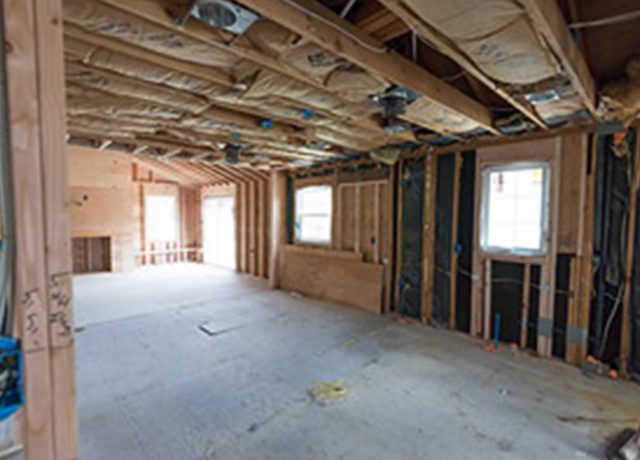 Unfinished room with exposed framing.