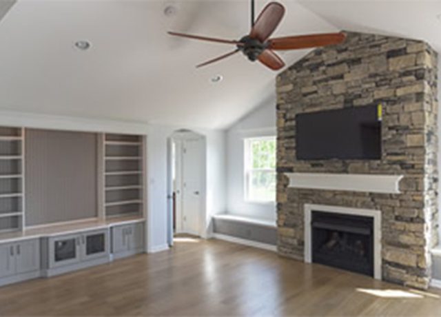 Modern living room with fireplace and TV.