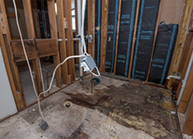 Water damaged bathroom floor and walls.