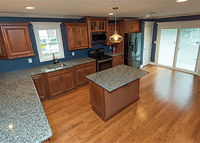 Kitchen with island and hardwood floors.