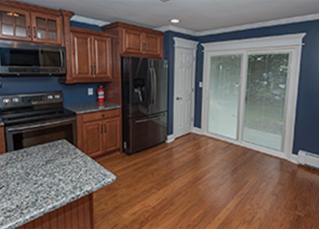 Kitchen with stainless steel appliances and hardwood floors.