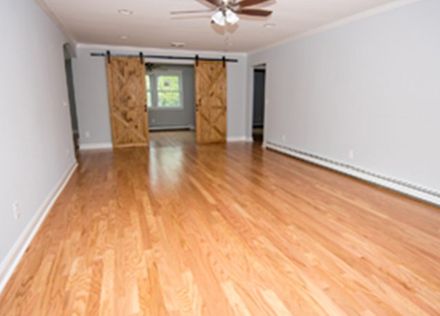 Hardwood floors in empty living room.