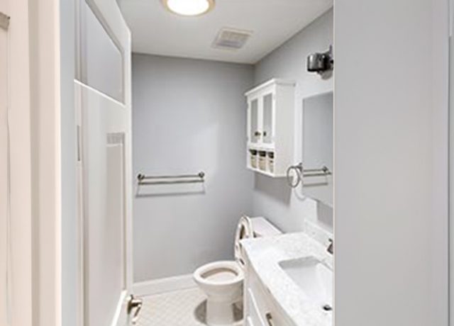 White bathroom with a toilet and sink.