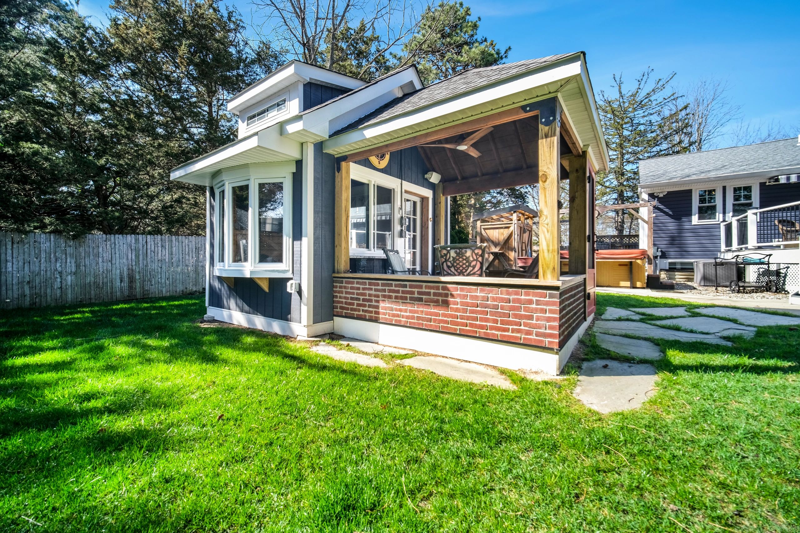 Brick patio and covered porch of a house.