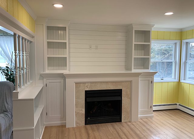 White fireplace with built-in shelves.