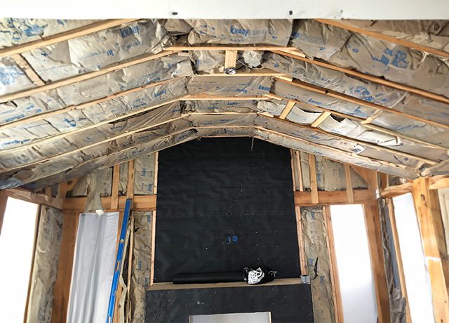 Unfinished room with fireplace framing.